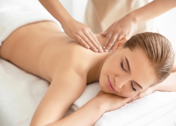 Young beautiful woman having massage in spa salon